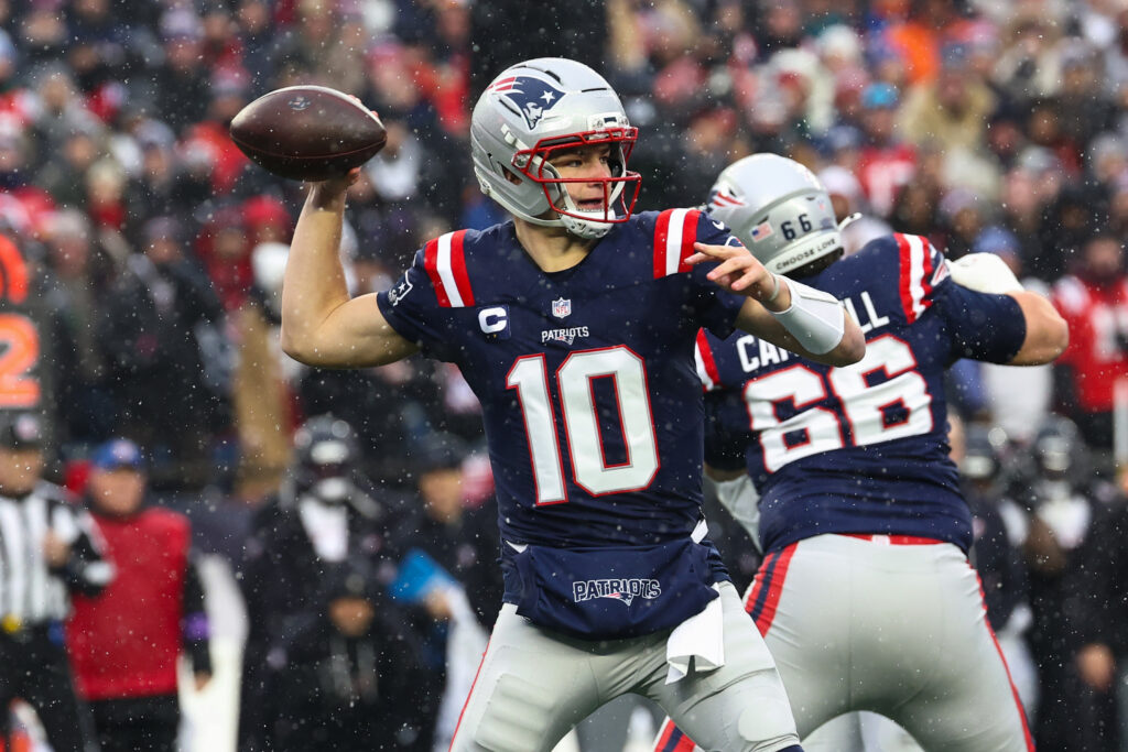 Drake Maye #10 of the New England Patriots passes against the Houston Texans during an NFL divisional playoff game at Gillette Stadium.