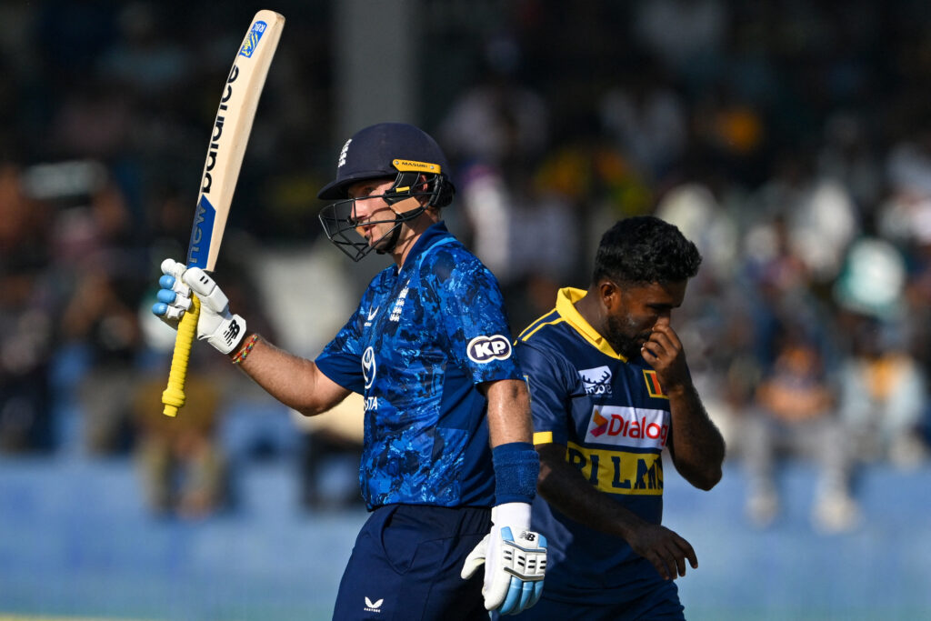 England's Joe Root (L) celebrates after scoring a half-century (50 runs) during the third one-day international (ODI) cricket match between Sri Lanka and England