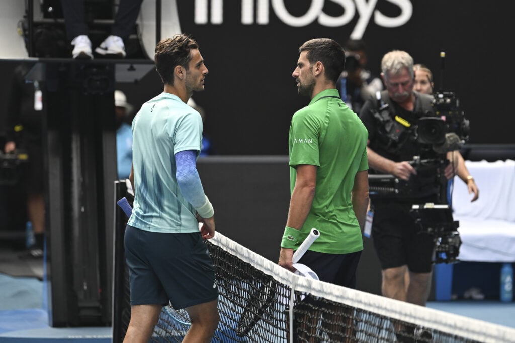 Lorenzo Musetti (ITA) with Novak Djokovic (SRB) after retiring with an injury during the Quarterfinals at the Australian Open grand slam tennis tournament at Melbourne Park.