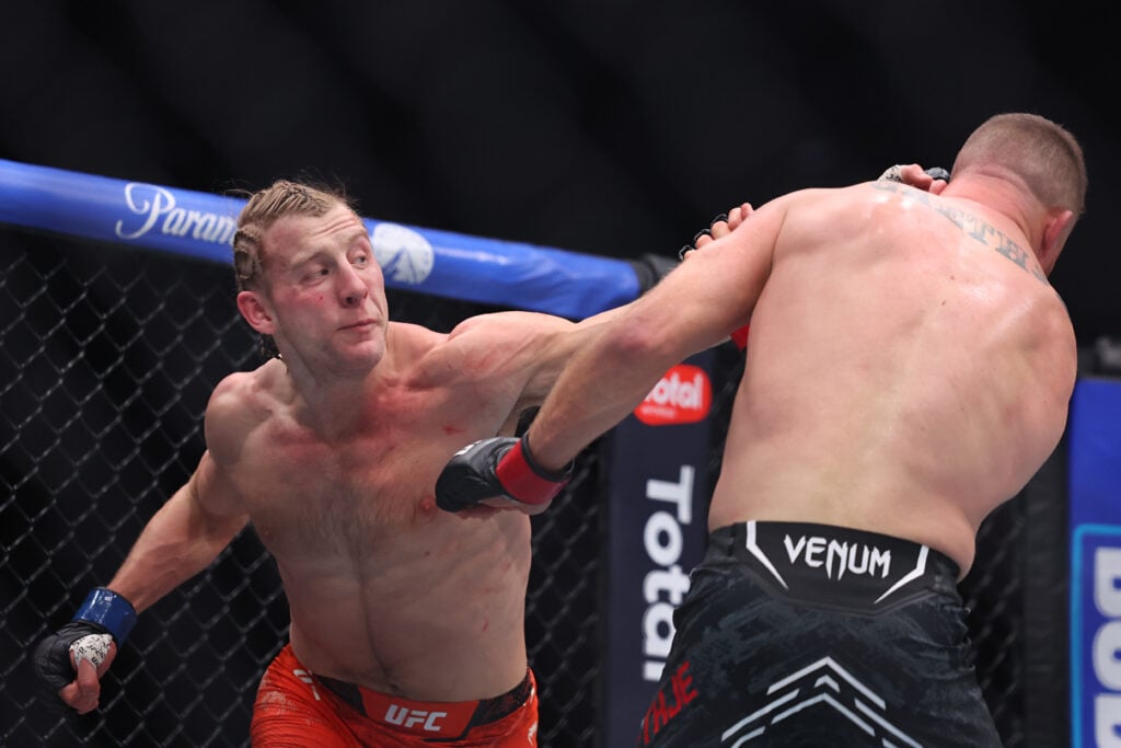 Paddy Pimblett of England strikes Justin Gaethje of the United States during their interim lightweight title bout in UFC 324 at T-Mobile Arena.