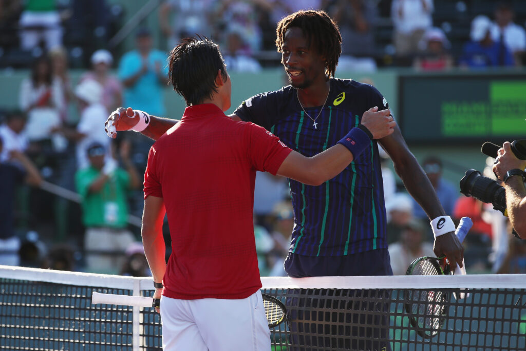 Kei Nishikori and Gael Monfils embrace at the 2016 Miami Open