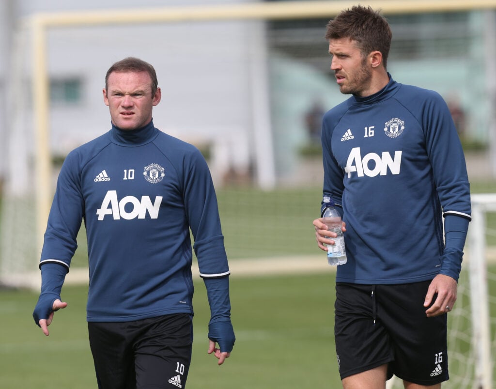 Wayne Rooney and Michael Carrick of Manchester United in action during a first team training session at Aon Training Complex.