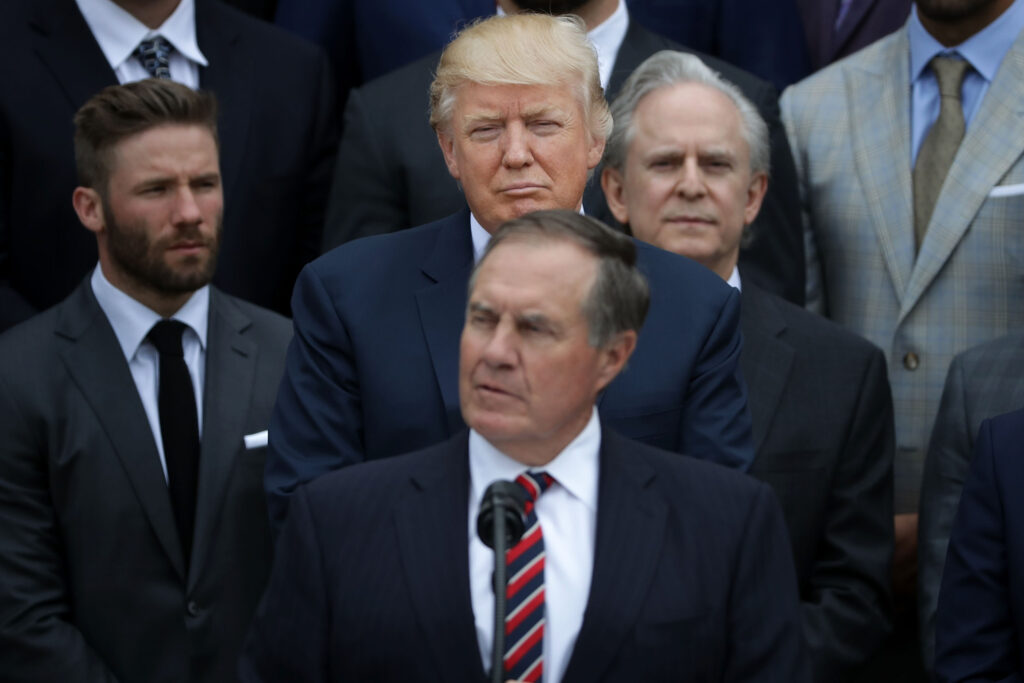 U.S. President Donald Trump (C) listens to New England Patriots Head Coach Bill Belichick deliver remarks during an event celebrating the team's Super Bowl win on the South Lawn at the White House.