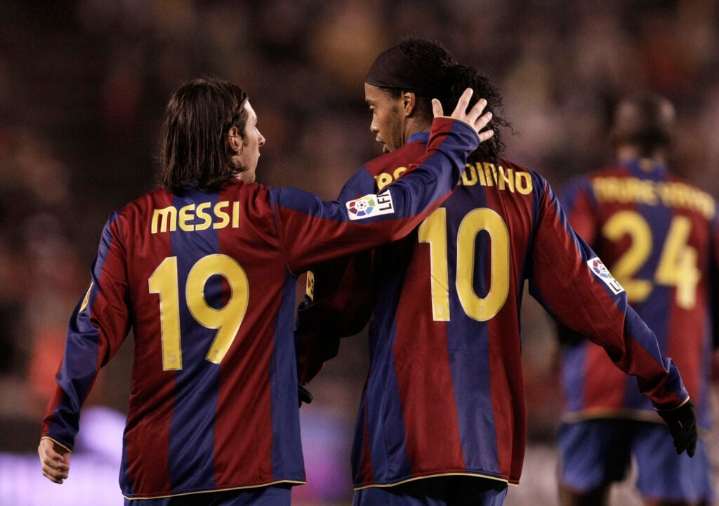 Lionel Messi of Barcelona congratulates Ronaldinho after he scored Barcelona's first goal during the La Liga match against Valladolid.