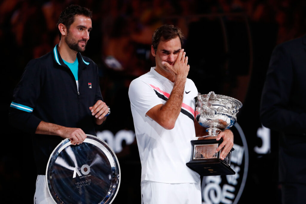 Marin Cilic (L) of Croatia poses with the runners-up trophy and an emotioinal Roger Federer of Switzerland poses with the Norman Brookes Challenge Cup after winning the 2018 Australian Open Men's Singles Final against on day 14 of the 2018 Australian Open at Melbourne Park on January 28, 2018 in Melbourne, Australia.