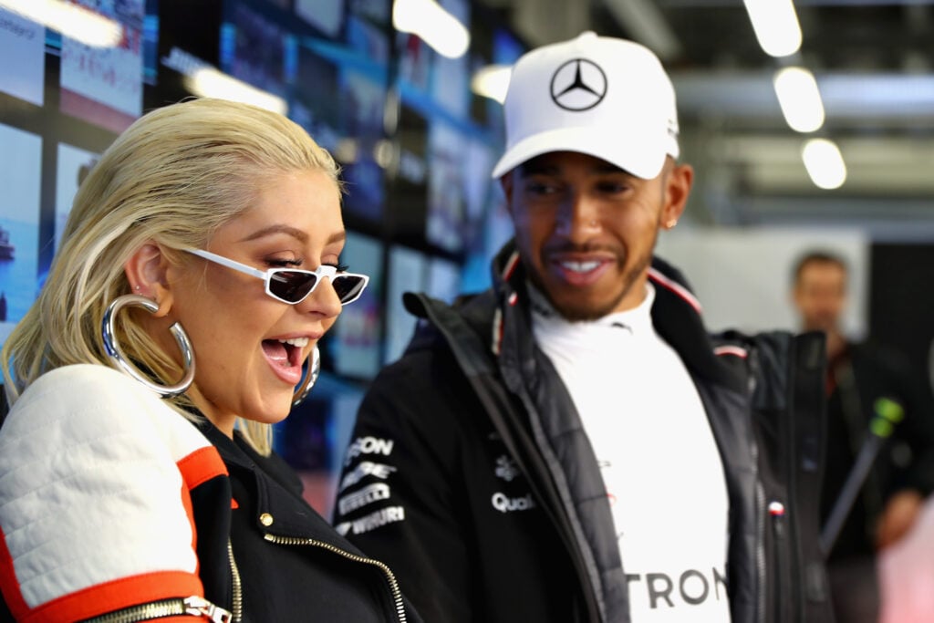 Lewis Hamilton talks to Christina Aguilera in the Mercedes garage at the 2018 F1 Azerbaijan Grand Prix