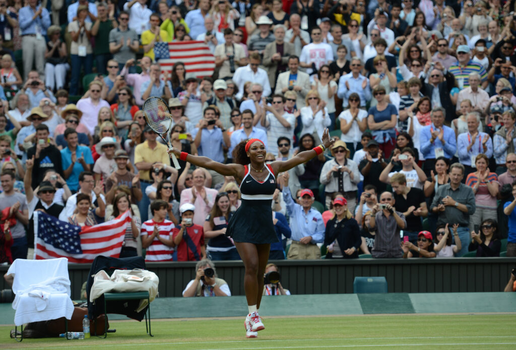 USA's Serena Williams celebrates her 6-0, 6-1 win against Russia's Maria Sharapova for the Women's Singles Tennis gold medal match at Wimbledon, Centre Court for the London 2012 Olympics in London, England on Saturday, Aug. 4, 2012.  (Nhat V. Meyer/Mercur