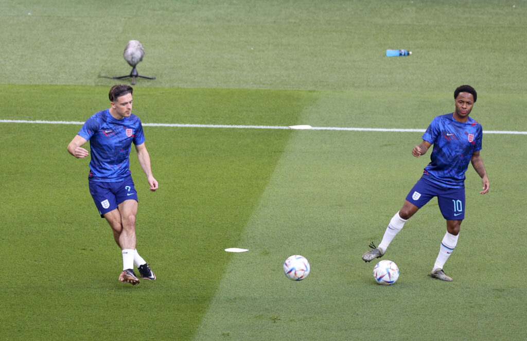 Jack Grealish (L) and Raheem Sterling (R) of England warm up ahead of FIFA World Cup Qatar 2022 Group B match between England and Iran