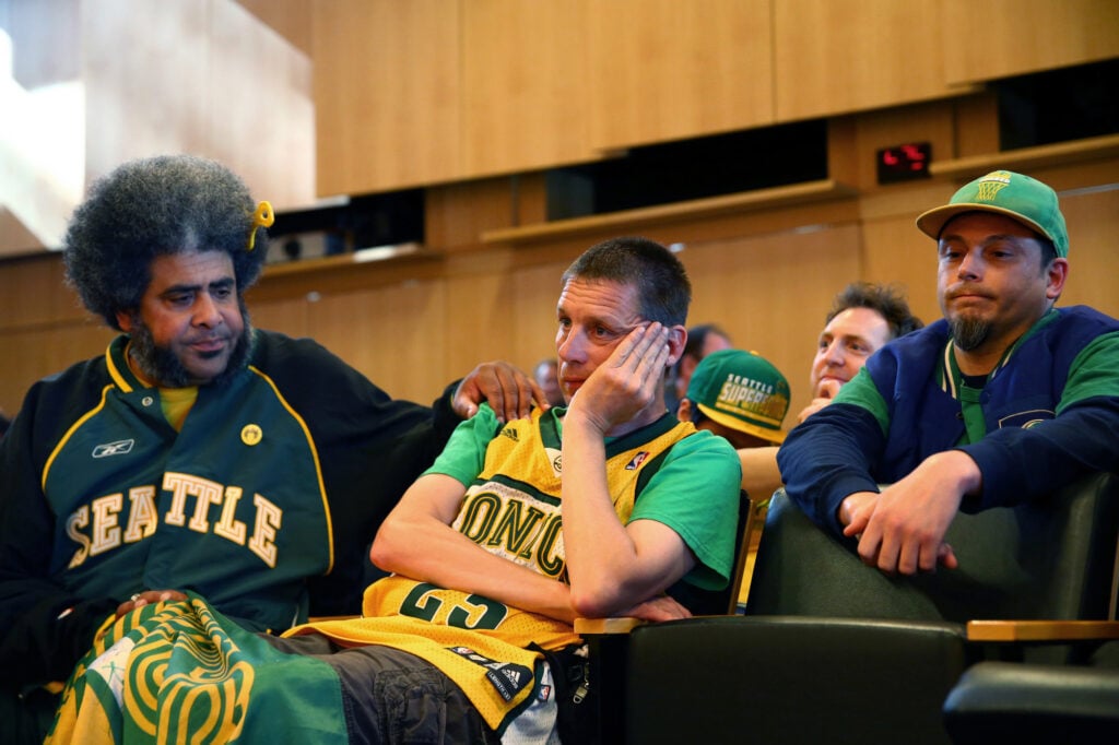 Seattle SuperSonics fans Kris ""Sonics Guy"" Brannon, left, Kenneth Knutsen, center, and Jason Billingsley react to the Seattle City Council's 5-4 no vote against a ""street vacation"" vacating stretch of road where investor Chris Hansen hopes to eventually build an arena that could house an NBA and NHL team.