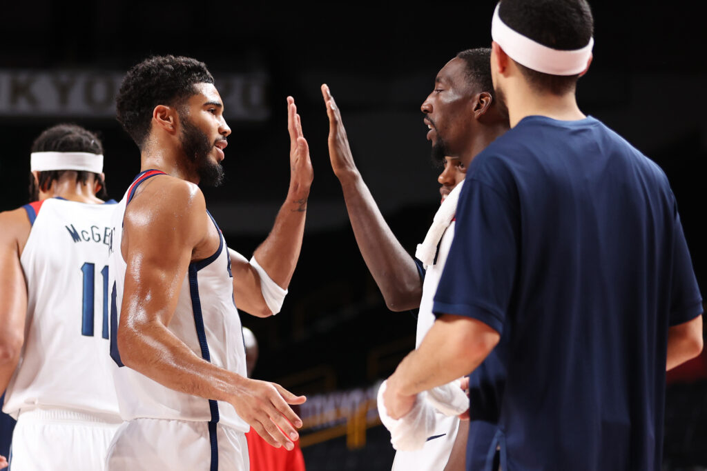 Jayson Tatum #10 of Team United States high-fives teammate Bam Adebayo #13 during the second half of a Men's Basketball Preliminary Round Group A game on day eight of the Tokyo 2020 Olympic Games at Saitama Super Arena on July 31, 2021 in Saitama, Japan.