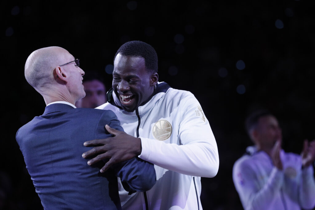 Draymond Green (23) hugs NBA Commissioner Adam Silver as he goes to recieve his championship ring before the Golden State Warriors played the Houston Rockets at Oracle Arena in Oakland, Calif., Tuesday, October 17, 2017.