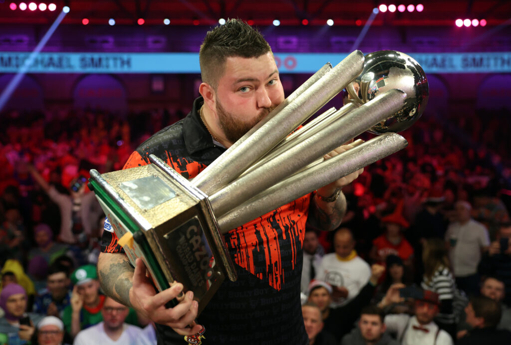 Michael Smith celebrates with the Trophy during the Finals against Michael van Gerwen of Netherlands during Day Fourteen of the Cazoo World Darts Championship