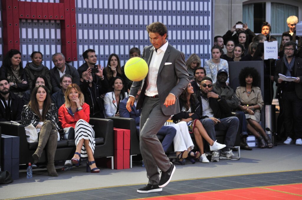 Rafael Nadal kicks a large tennis ball