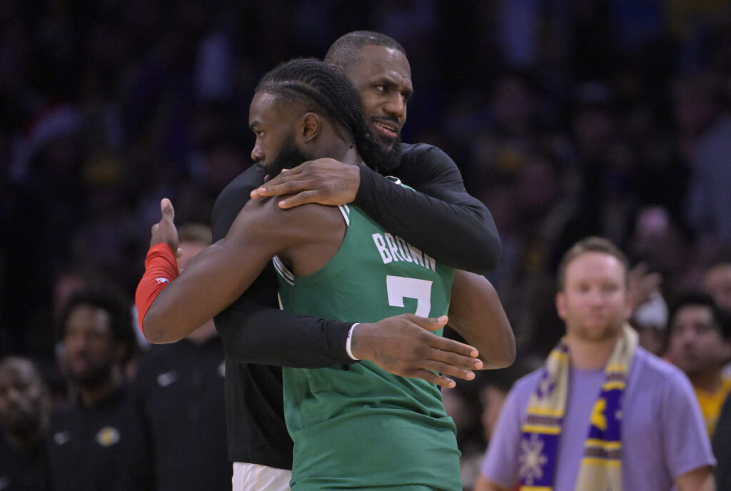 Jaylen Brown #7 of the Boston Celtics talks with LeBron James #23 of the Los Angeles Lakers after the game at Crypto.com Arena on December 25, 2023 in Los Angeles, California.