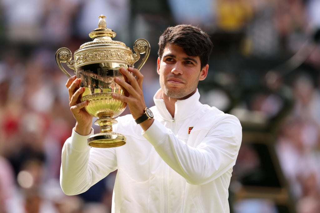 Carlos Alcaraz of Spain poses with the Gentlemen's Singles Trophy following victory against Novak Djokovic of Serbia in the Gentlemen's Singles Final during day fourteen of The Championships Wimbledon 2024