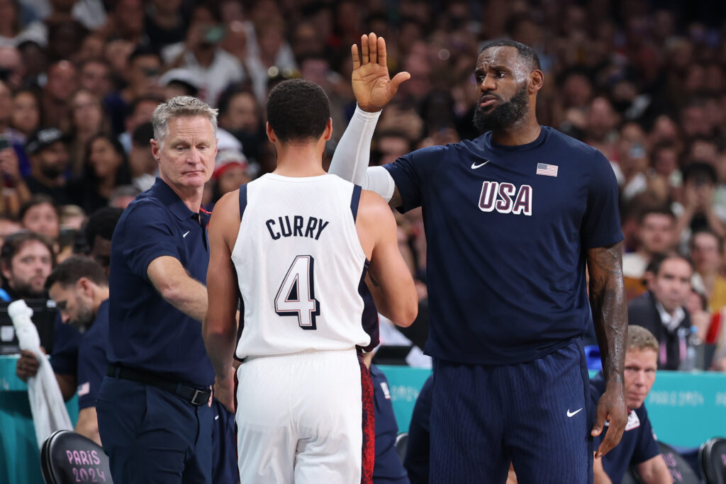 Head coach Steve Kerr and LeBron James #6 of Team United States high five Stephen Curry #4 of Team United States during a Men's Group Phase - Group C game between the United States and South Sudan on day five of the Olympic Games Paris 2024 at Stade Pierre Mauroy.