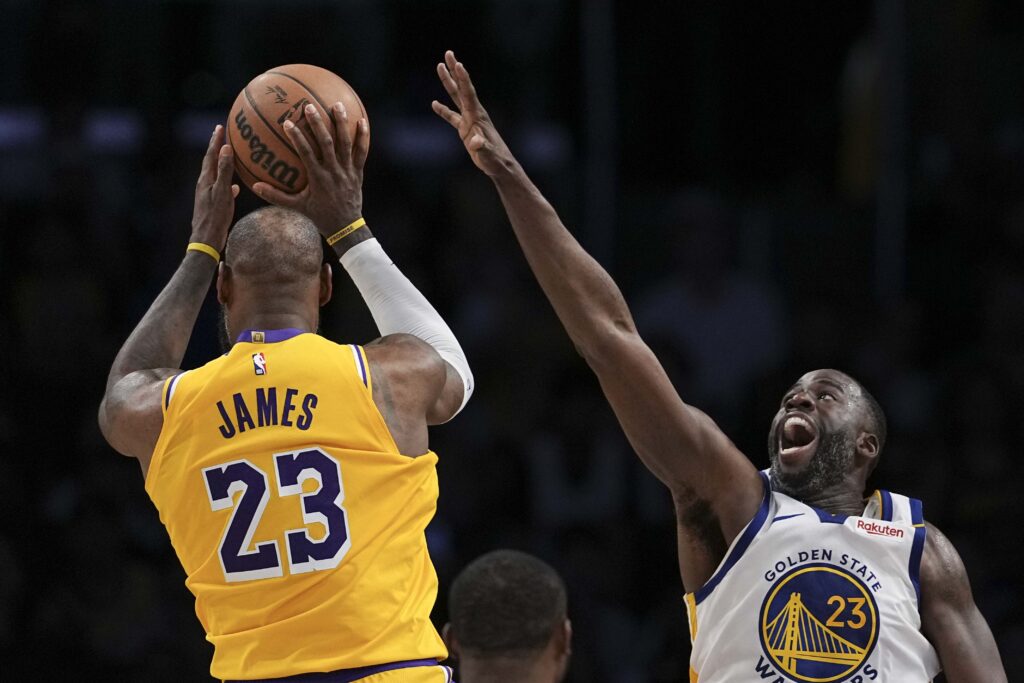 LeBron James #23 of the Los Angeles Lakers looks to pass against Draymond Green #23 of the Golden State Warriors during the second half of a game at Crypto.com Arena on April 03, 2025 in Los Angeles, California.