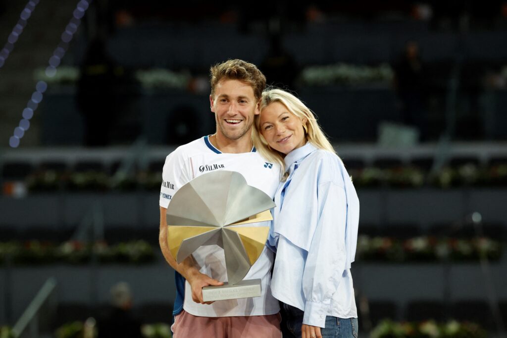 Casper Ruud pictured holding the Madrid Open trophy alongside his partner Maria Galligani in 2025.