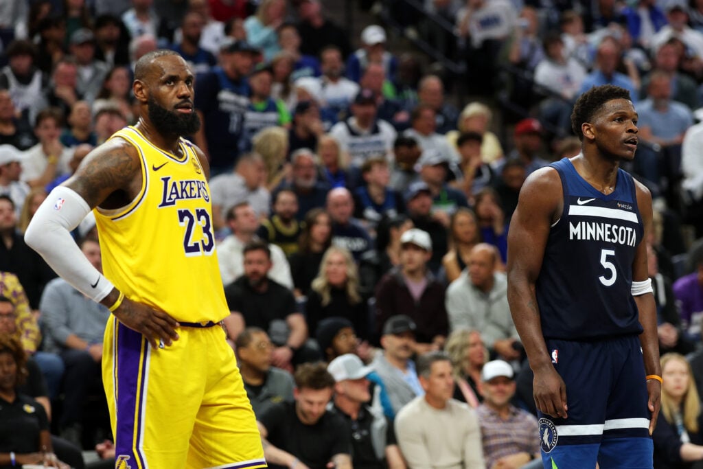 LeBron James #23 of the Los Angeles Lakers and Anthony Edwards #5 of the Minnesota Timberwolves look on in the third quarter of Game Three of the First Round of the 2025 NBA Playoffs.