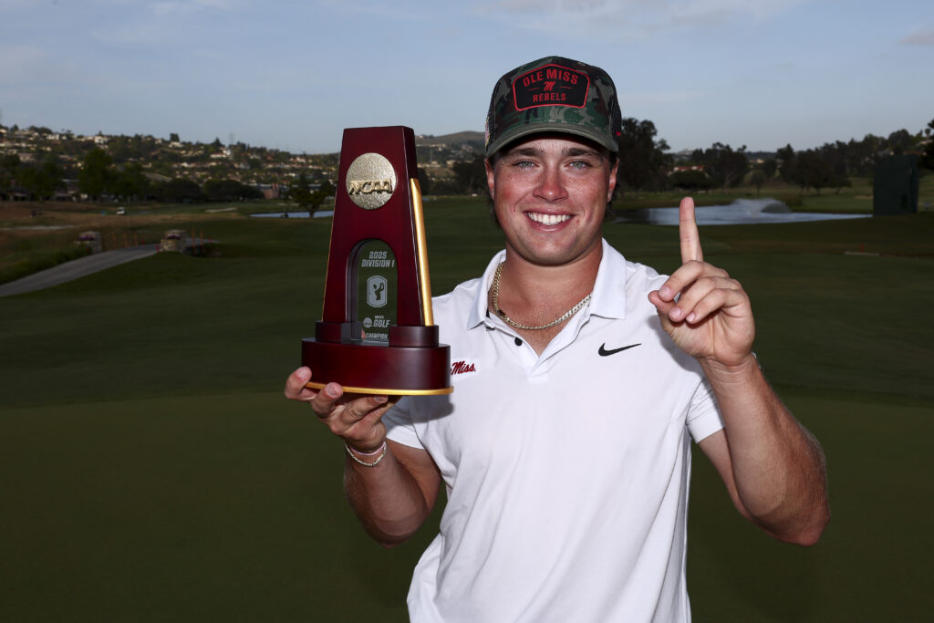 Michael La Sasso of the Ole Miss Rebels celebrates with the NCAA Individual Champion Trophy