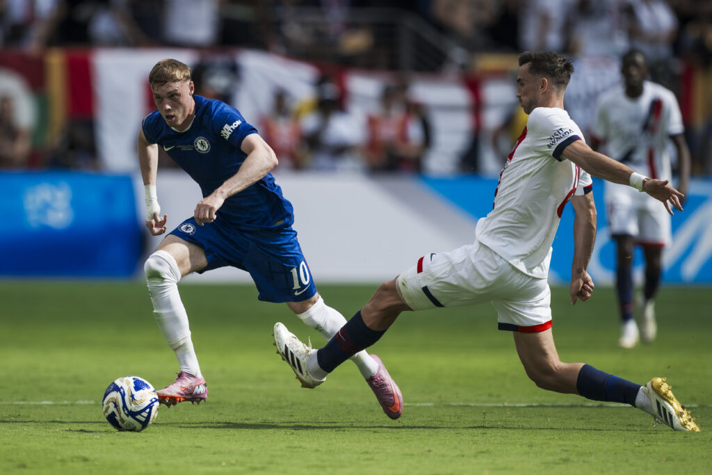 Cole Palmer (L) of Chelsea FC is challenged by Fabian Ruiz