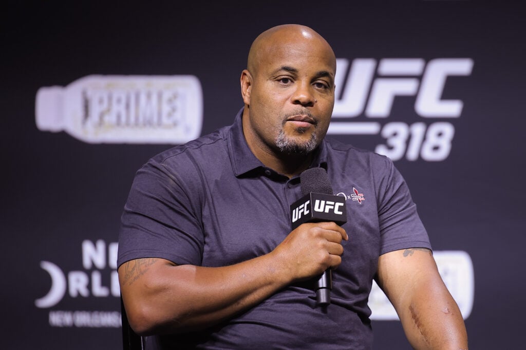 Daniel Cormier is seen on stage during a Q&A session prior to the UFC 318 ceremonial weigh-ins at Smoothie King Center.