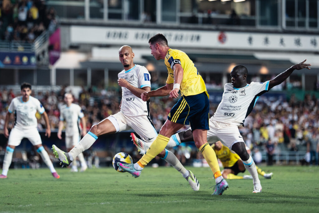 Cristiano Ronaldo, forward of Al-Nassr shoots in front of Al-Ittihad midfielders, Fabinho and N'Golo Kanté during the Saudi Super Cup semi final between Al-Nassr and Al-Ittihad at Hong Kong Stadium on August 19, 2025 in Hong Kong, China.