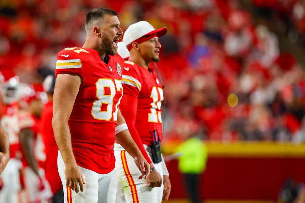 Travis Kelce #87 of the Kansas City Chiefs and Patrick Mahomes #15 of the Kansas City Chiefs watch second quarter game action during the NFL Preseason 2025 game between Chicago Bears and Kansas City Chiefs at Arrowhead Stadium on August 22, 2025 in Kansas City, Missouri.