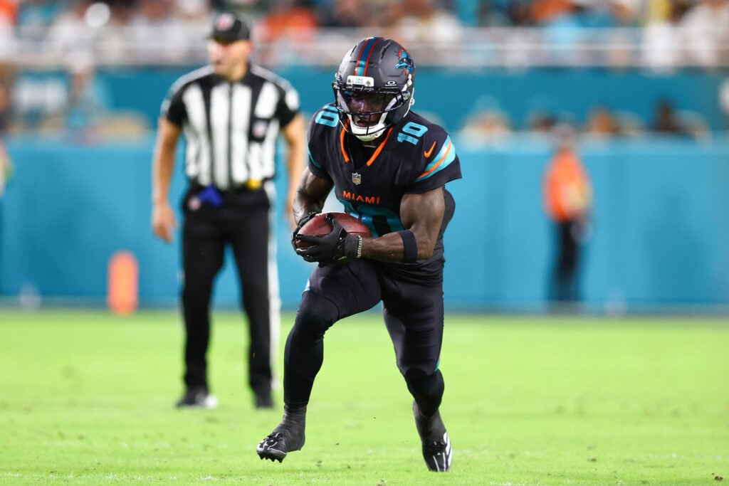 Tyreek Hill #10 of the Miami Dolphins carries the ball after a reception against the New York Jets during the first half of the game at Hard Rock Stadium
