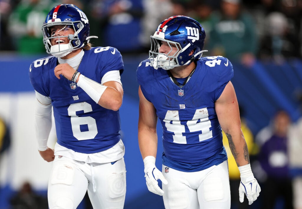 Jaxson Dart #6 and Cam Skattebo #44 of the New York Giants celebrate after Skattebo carried the ball into the endzone for a touchdown during the second quarter of the game against the Philadelphia Eagles at MetLife Stadium on October 09, 2025 in East Rutherford, New Jersey.