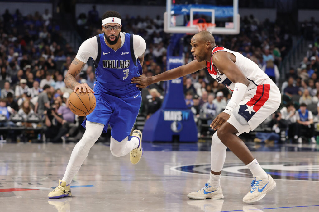 Anthony Davis #3 of the Dallas Mavericks drives to the basket against Khris Middleton #22 of the Washington Wizards during a game at American Airlines Center on October 24, 2025.