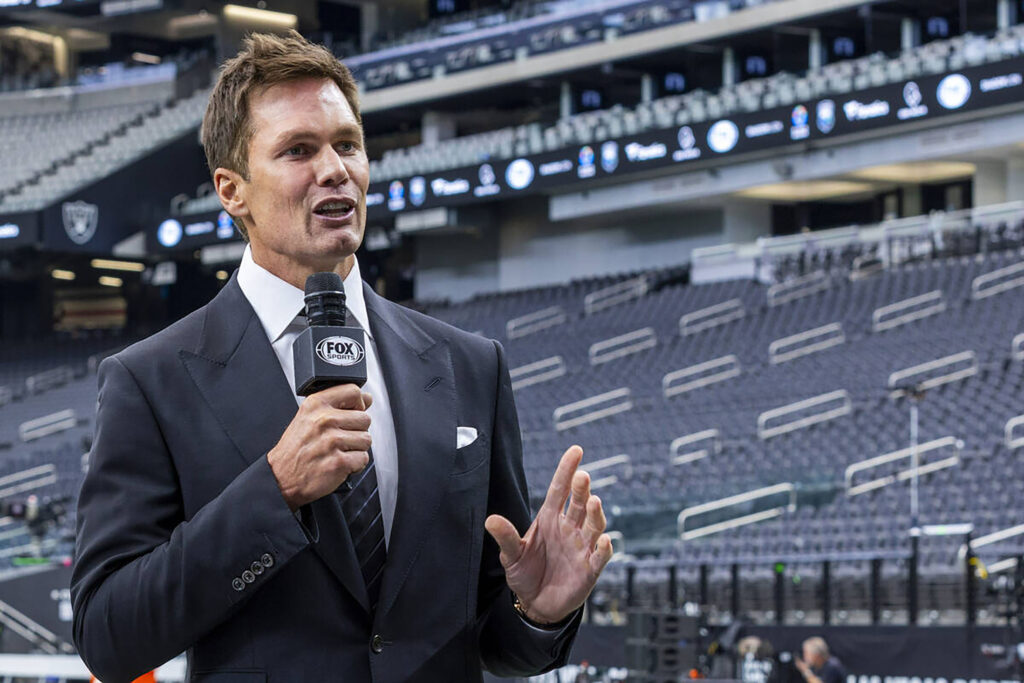 Raiders minority owner and Fox football analyst Tom Brady talks at Allegiant Stadium.