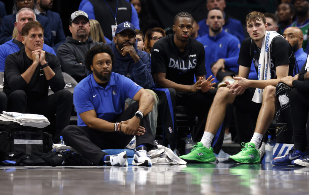 Mark Cuban and Cooper Flagg #32 of the Dallas Mavericks looks on during the second half against the Memphis Grizzlies at American Airlines Center on November 22, 2025 in Dallas, Texas.