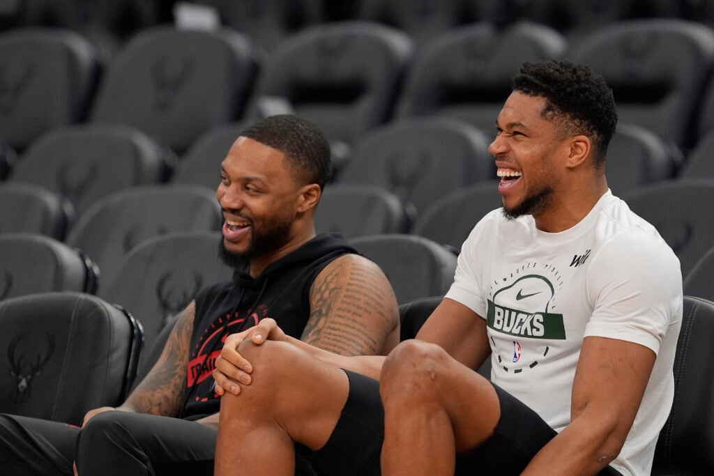 Damian Lillard #0 of the Portland Trail Blazers and Giannis Antetokounmpo #34 of the Milwaukee Bucks talk before a game at Fiserv Forum.