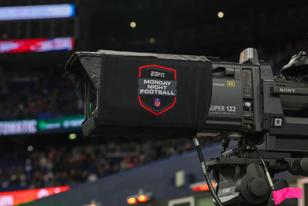 ESPN Monday Night Football signage on a TV camera before a game between the New England Patriots and the New York Giants on December 1, 2025, at Gillette Stadium.