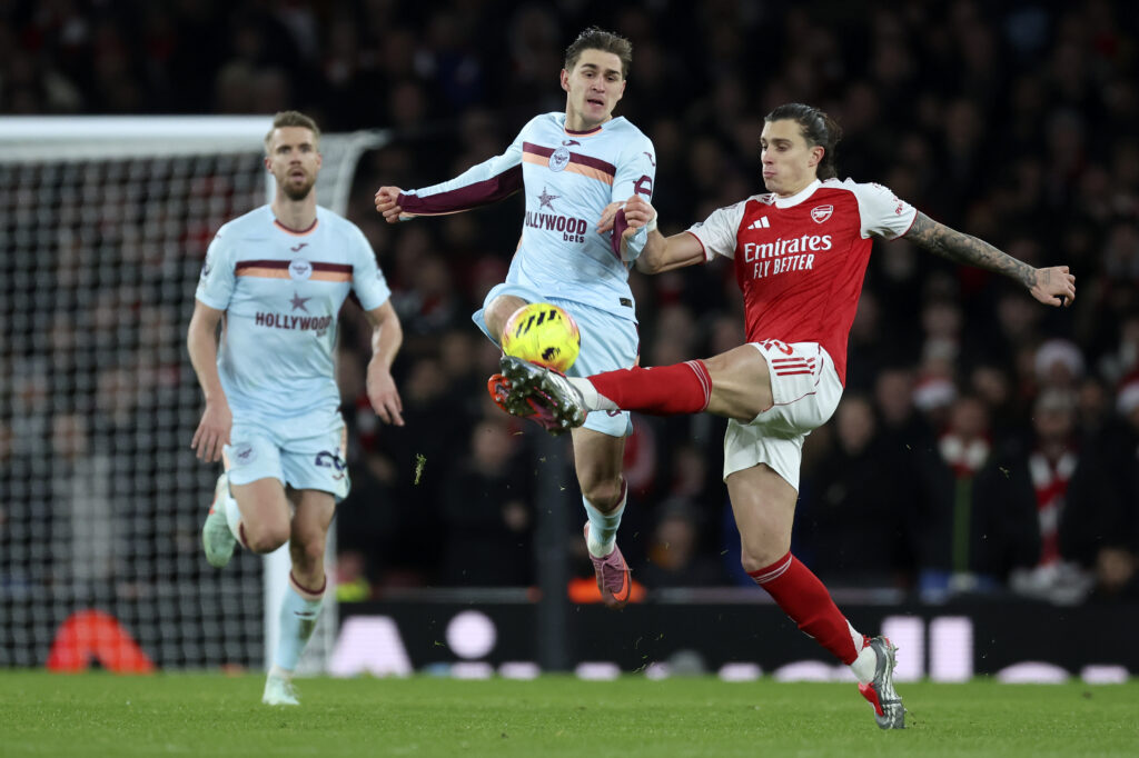 Yehor Yarmolyuk of Brentford and Riccardo Calafiori of Arsenal challenge during the Premier League match between Arsenal and Brentford at Emirates Stadium on December 3, 2025 in London, England.