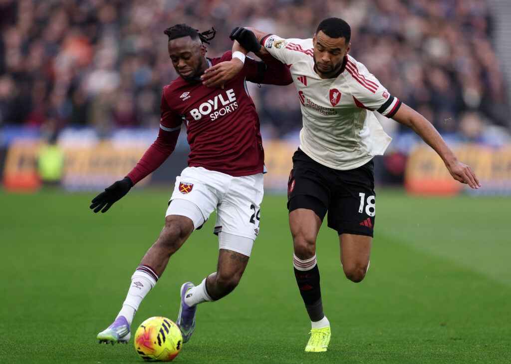Aaron Wan-Bissaka of West Ham United battles for possession with Cody Gakpo of Liverpool during the Premier League match between West Ham United and Liverpool at London Stadium on November 30, 2025 in London, England.