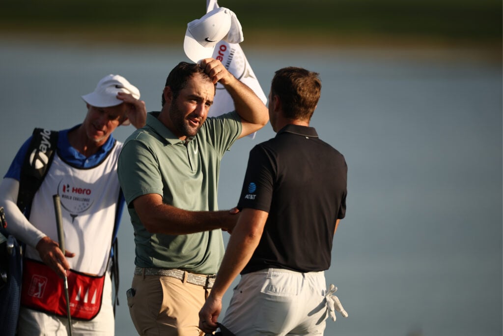 Scottie Scheffler of the United States shakes hands with Jordan Spieth of the United States after his round on the 18th green during the first round of the Hero World Challenge 2025