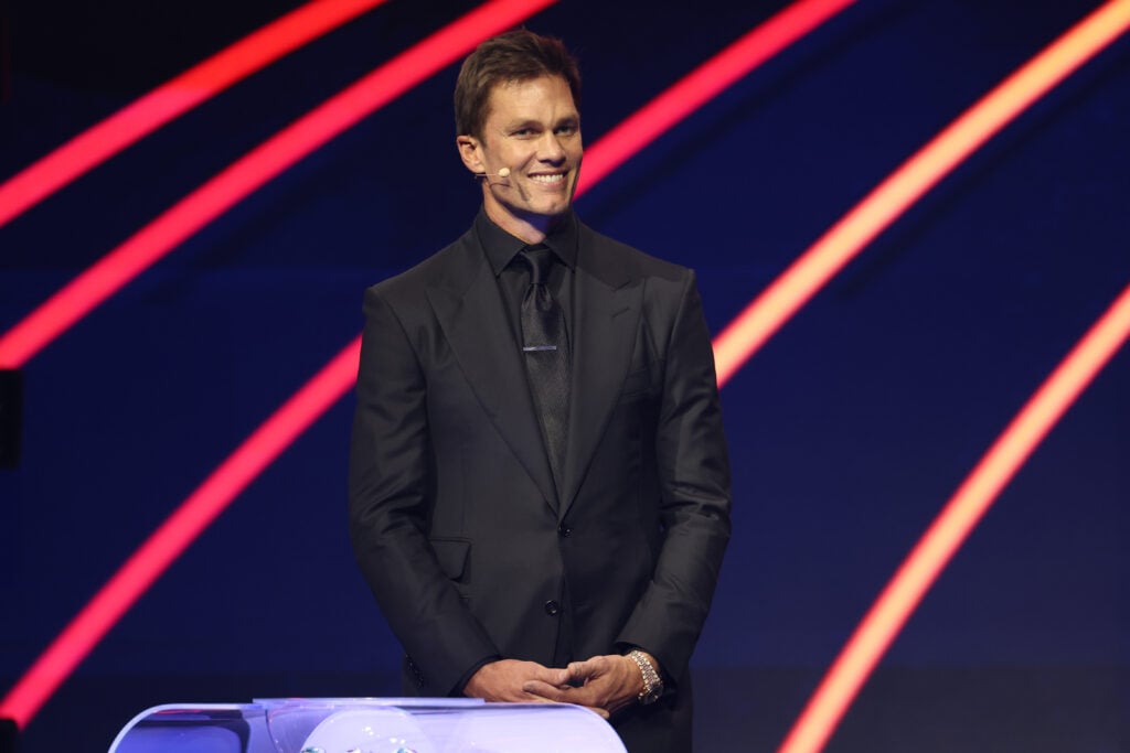 Draw assistant Tom Brady reacts on stage during the FIFA World Cup 2026 Official Draw at John F. Kennedy Center for the Performing Arts.