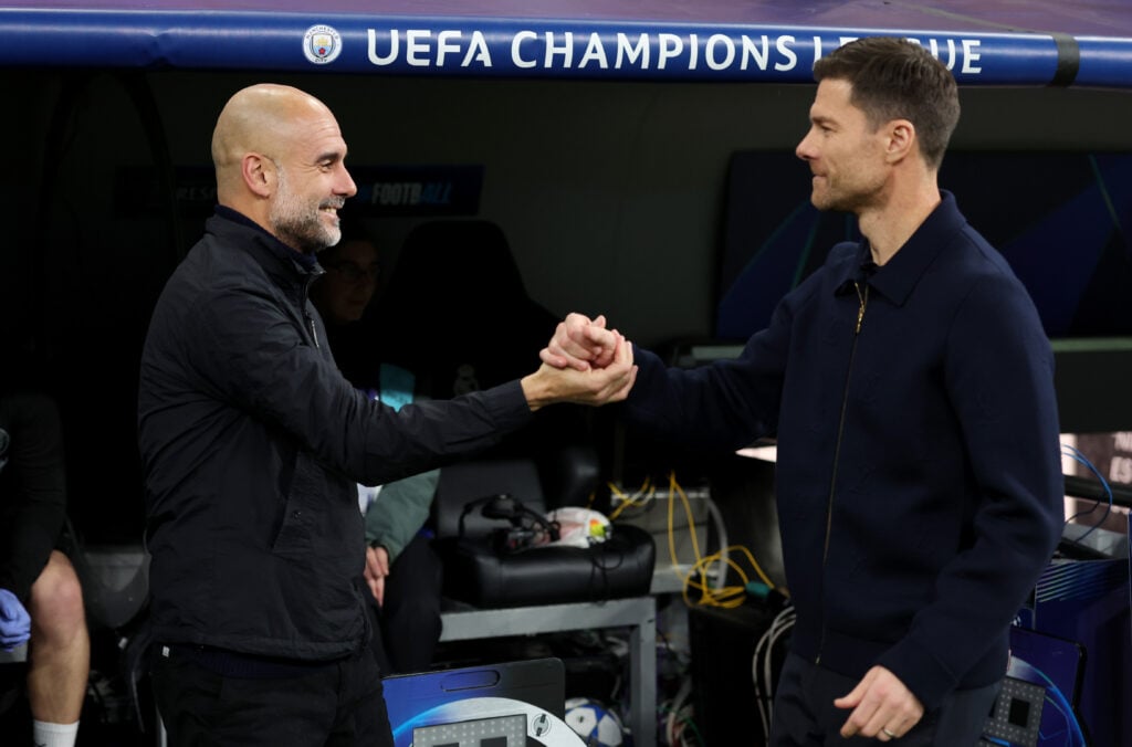 Pep Guardiola, Manager of Manchester City, and Xabi Alonso, Head Coach of Real Madrid, embrace prior to the UEFA Champions League 2025/26 League Phase MD6 match between Real Madrid C.F. and Manchester City at Estadio Santiago Bernabeu.