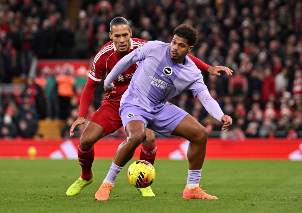 Georginio Rutter of Brighton & Hove Albion is challenged by Virgil van Dijk of Liverpool during the Premier League match between Liverpool and Brighton & Hove Albion at Anfield on December 13, 2025 in Liverpool, England.
