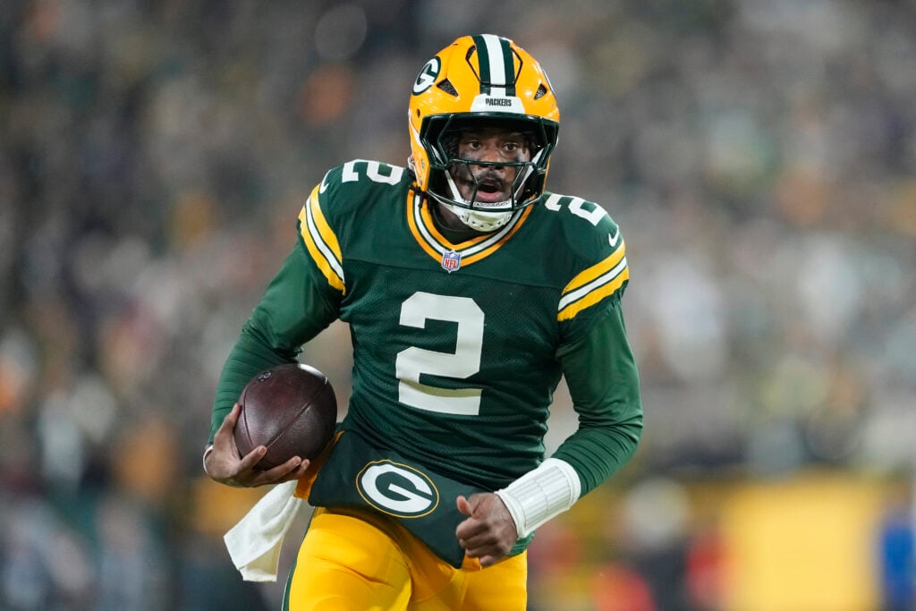 Malik Willis #2 of the Green Bay Packers runs with the ball for a touchdown in the second quarter against the Baltimore Ravens at Lambeau Field.