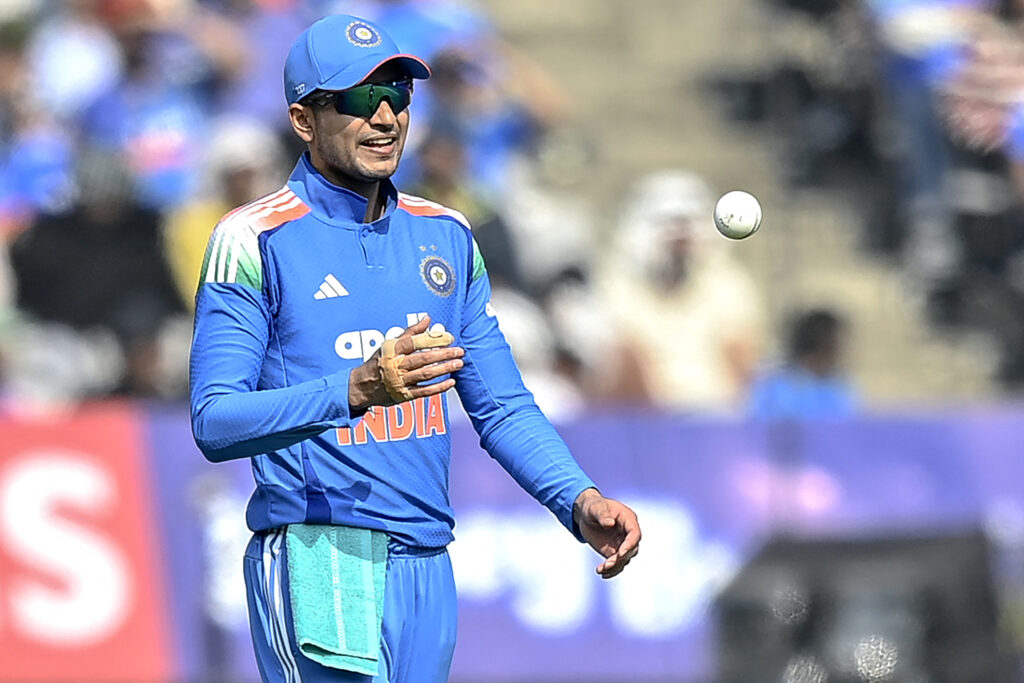 India's captain Shubman Gill tosses the ball during the first one-day international (ODI) cricket match between India and New Zealand at the Kotambi Stadium.