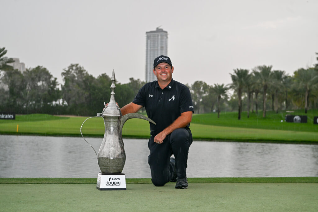 American golfer Patrick Reed wins the trophy after competing against Spanish golfer David Puig in the fourth and final round of the Hero Dubai Desert Classic 2026