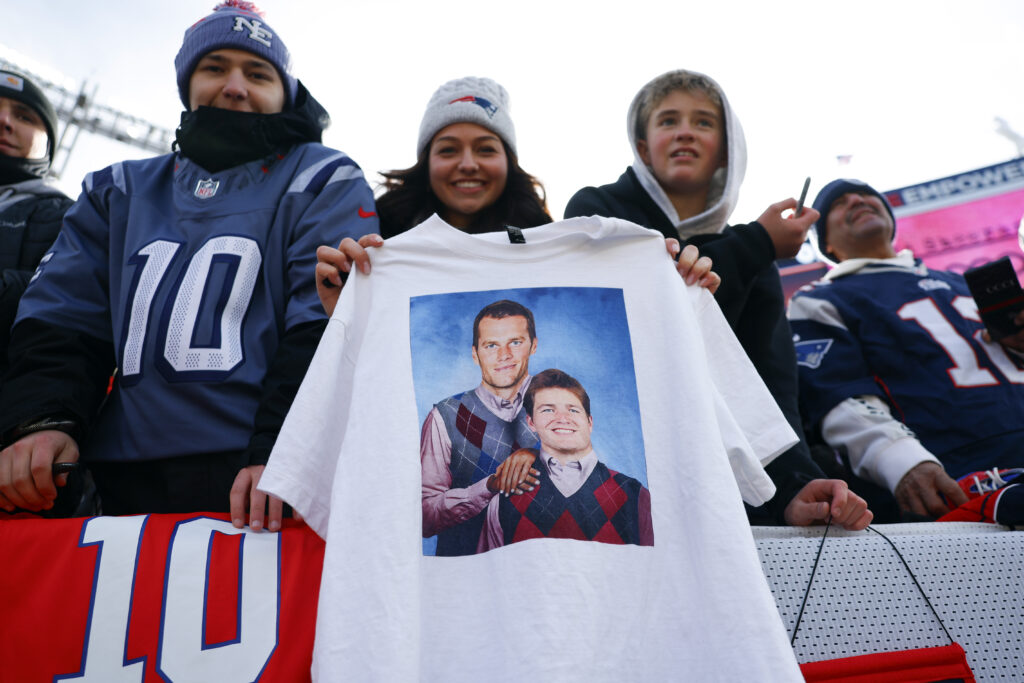 England Patriots fans hold up a "Step Brothers" inspired shirt featuring Tom Brady and Drake Maye before the game. The New England Patriots played the Denver Broncos in the AFC Championship Game at Empower Field at Mile High on January 25, 2026.