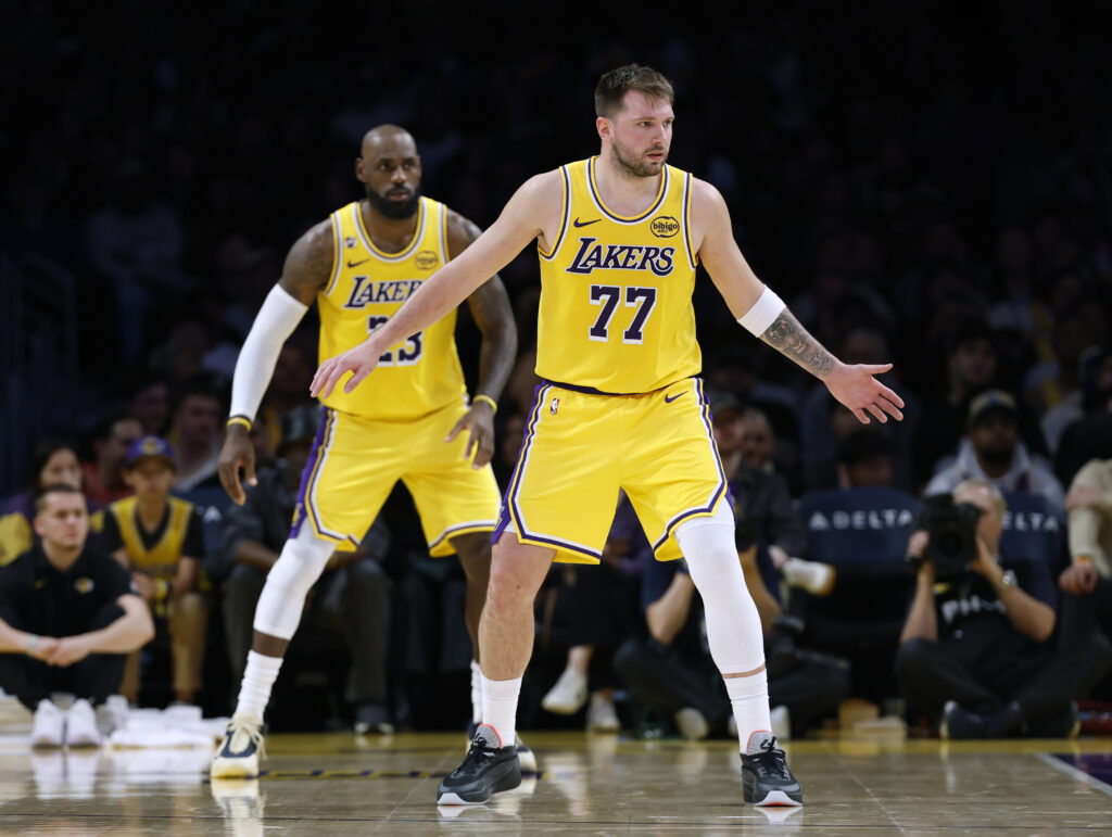 Luka Doncic #77 of the Los Angeles Lakers and LeBron James #23 of the Los Angeles Lakers defend during a 135-117 loss to the Charlotte Hornets at Crypto.com Arena.