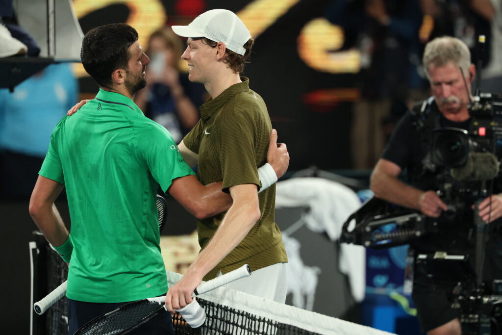 Novak Djokovic and Jannik Sinner embrace after their semifinal match at the 2026 Australian Open