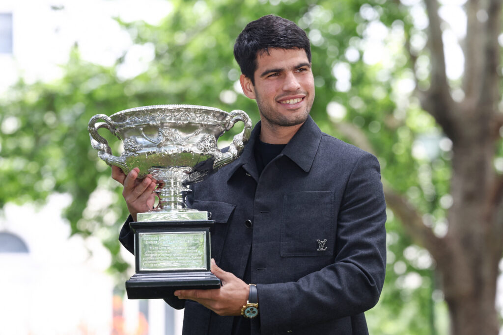 Spain's Carlos Alcaraz poses with the Norman Brookes Challenge Cup at the Royal Exhibition Building following his victory against Serbia's Novak Djokovic in the men's singles final match of the Australian Open tennis tournament in Melbourne on February 2, 2026.