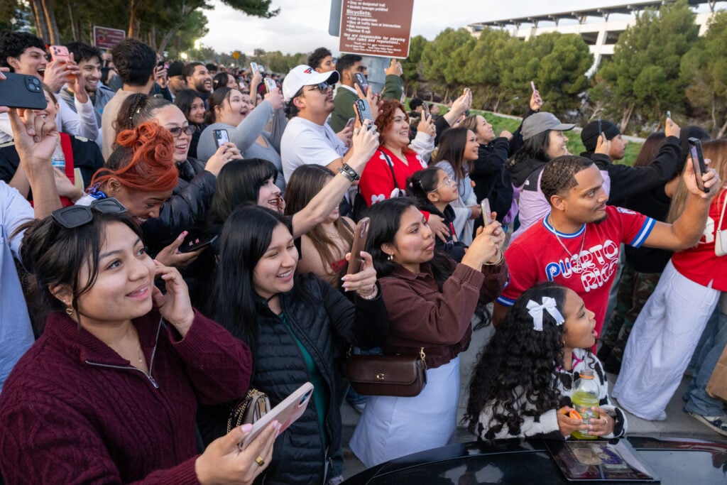 Bad Bunny fans without Super Bowl LX tickets watch from outside Levi's Stadium as fireworks fill the sky during the Puerto Rican singer's Apple Music Halftime Show performance in Santa Clara, California.