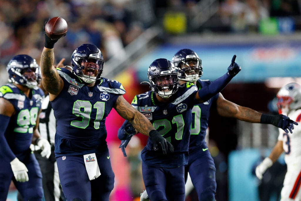 Seattle Seahawks Byron Murphy II (91) and Devon Witherspoon (21) celebrate after Murphy recovered a Patriots fumble after a sack during the third quarter of Super Bowl LX between the Seattle Seahawks and New England Patriots.